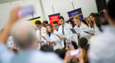 medical students in white coats at event