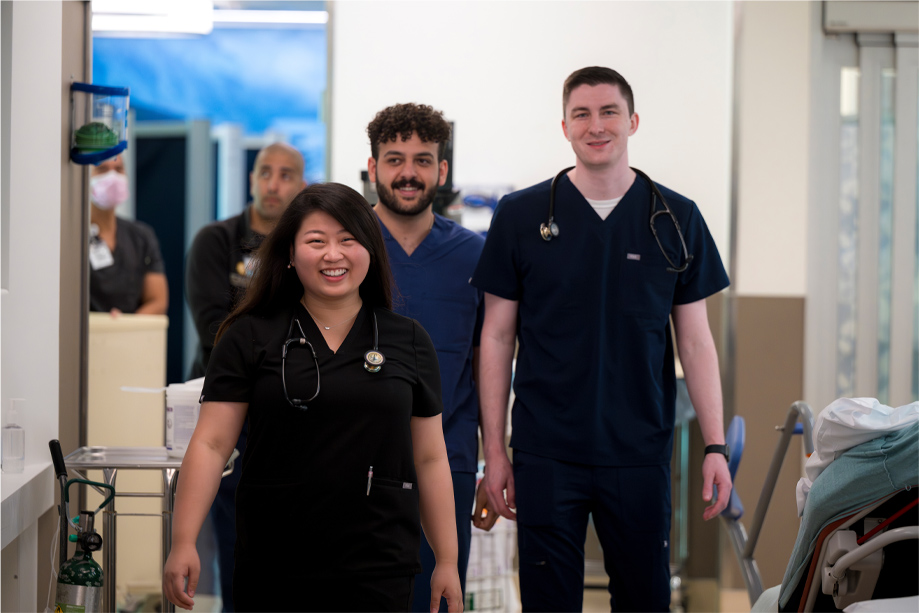 students smiling in scrubs