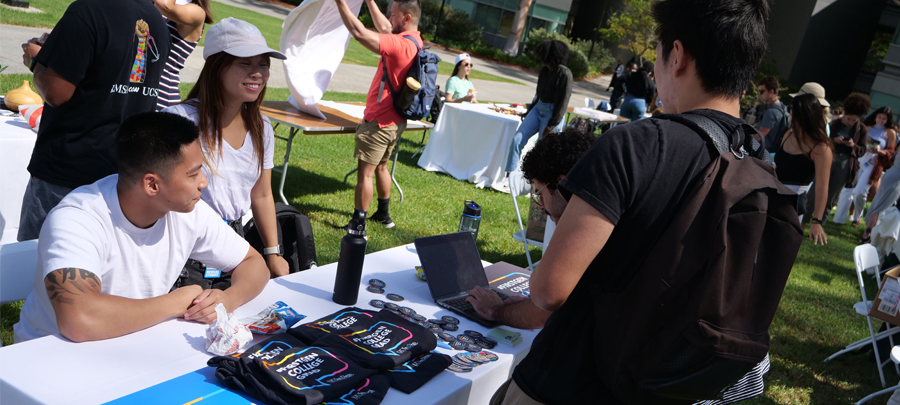 Students talking at the First Gen in Medicine table at the club fair.