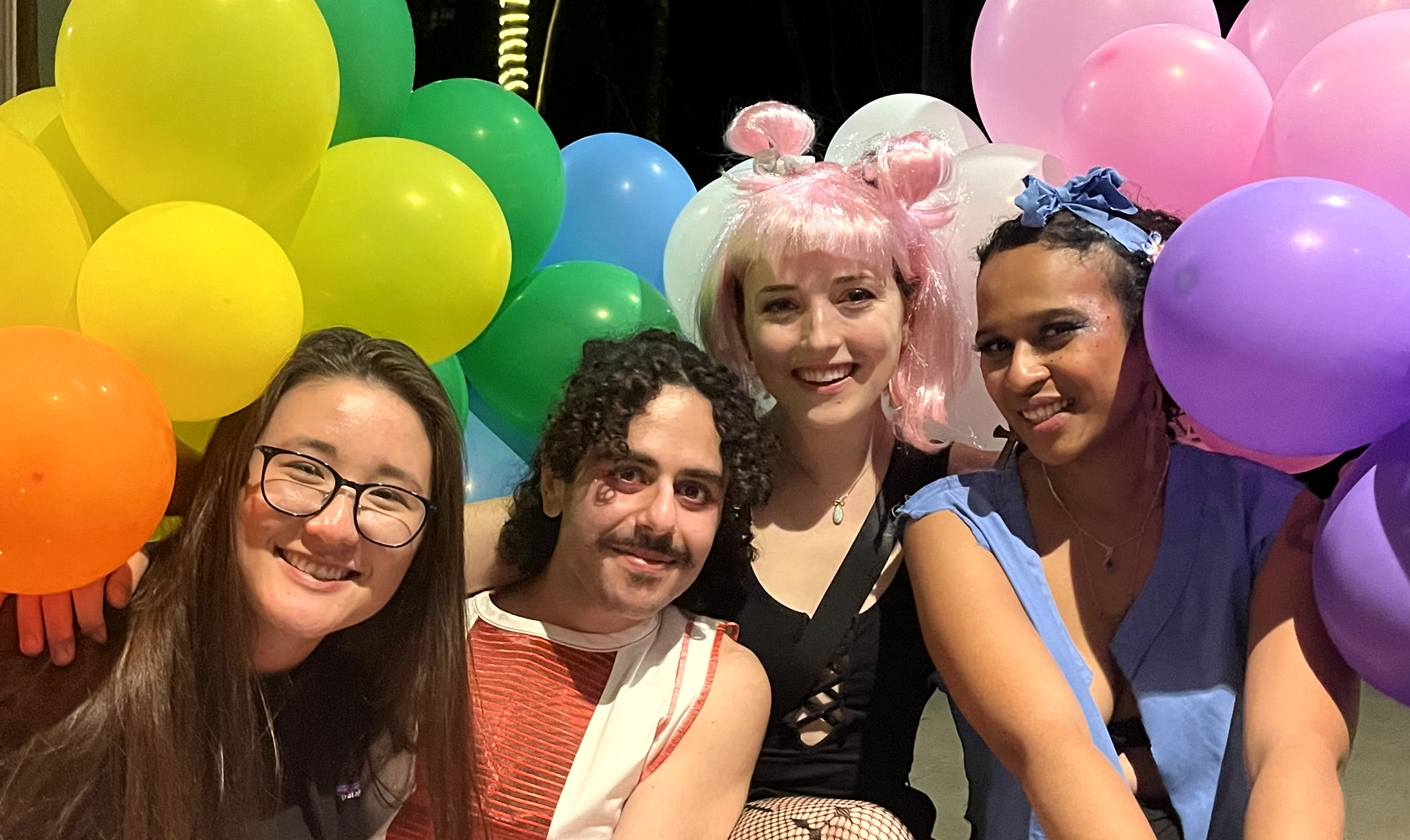 Group photos of smiling students with rainbow colored balloons in background