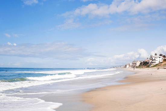 Photo of the San Diego coastline on a blue-sky day