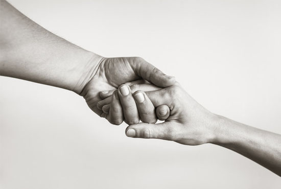 black and white image of two hands together