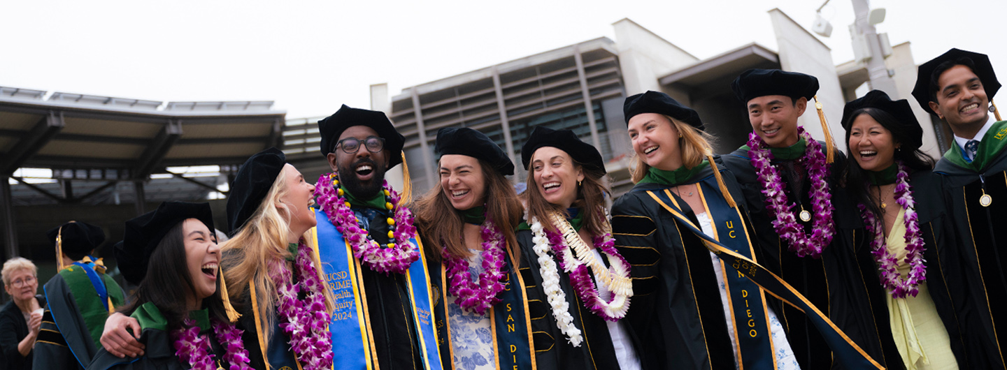 medical students in graduation gowns at commencement ceremony