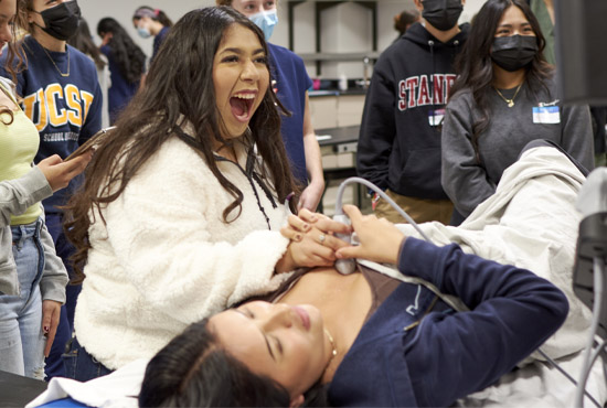 high school student reacting with joy to using ultrasound technology