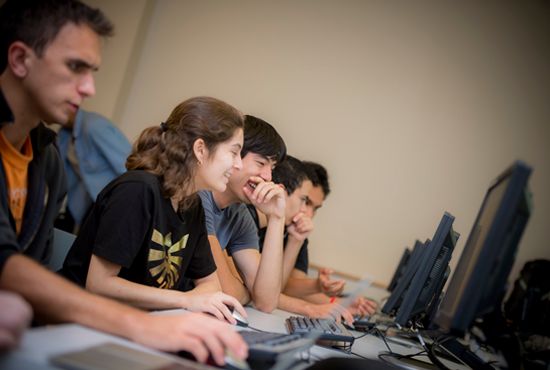 Students smiling at computers
