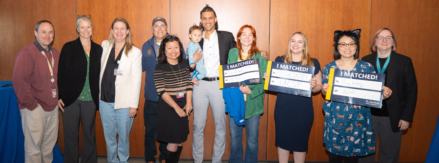 1 of 11, Group photo of students and faculty, students are holding "I Matched" signs