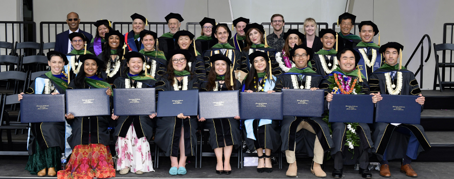 7 of 7, Group photo of MSTP students on stage in graduation regalia