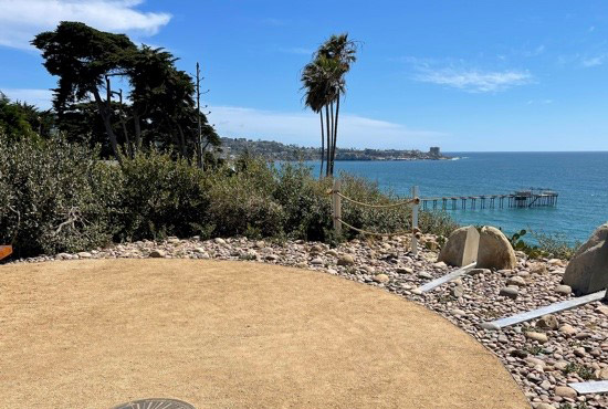 Memorial site overlooking the ocean pier in he background