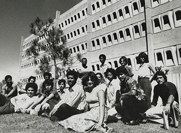 Old black and white photo of medical students sitting on the lawn in front of the Basic Sciences Building